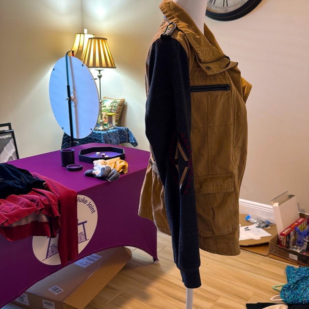 Zip up and snaps up jacket/jean material, sleeves are comfy sweatshirt material
